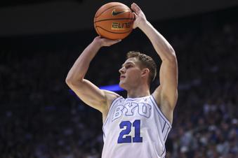 BYU guard Trevin Knell shoots a 3-point shot against Kansas during the first half of an NCAA college basketball game, Tuesday, Feb. 18, 2025, in Provo, Utah. (AP Photo/Rob Gray)