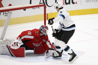 Utah Hockey Club center Nick Schmaltz (8) scores during the shootout of an NHL hockey game against Washington Capitals goaltender Logan Thompson (48), Sunday, Feb. 9, 2025, in Washington. (AP Photo/Nick Wass)