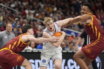 Brigham Young's Richie Saunders, center, fights his way past Iowa State's Nate Heise and Dishon Jackson, right, during the second half of an NCAA college basketball game in the quarterfinal round of the Big 12 Conference tournament, Thursday, March 13, 2025, in Kansas City, Mo. (AP Photo/Charlie Riedel)