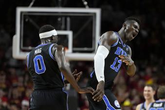BYU center Keba Keita (13) celebrates with teammate forward Mawot Mag (0) during the first half of an NCAA college basketball game against Iowa State, Tuesday, March 4, 2025, in Ames, Iowa. (AP Photo/Charlie Neibergall)