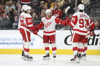 Detroit Red Wings right wing Alex DeBrincat (93) celebrates with teammates after his goal during the third period of an NHL hockey game against the Vegas Golden Knights, Saturday, March 22, 2025, in Las Vegas. (AP Photo/Ian Maule)