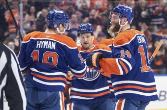 Edmonton Oilers' Zach Hyman (18), Mattias Ekholm (14) and Jeff Skinner (53) celebrate a goal against the Utah Hockey Club during second period NHL action in Edmonton on Tuesday, March 18, 2025. (Jason Franson/The Canadian Press via AP)