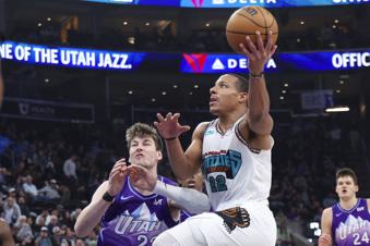 Memphis Grizzlies guard Desmond Bane, right, goes to the basket against Utah Jazz forward Kyle Filipowski, left, during the second half of an NBA basketball game, Tuesday, March 25, 2025, in Salt Lake City. (AP Photo/Rob Gray)