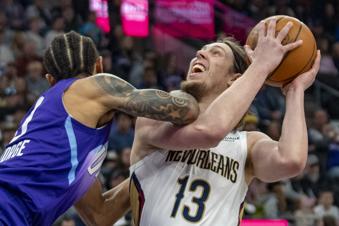 New Orleans Pelicans forward Kelly Olynyk (13) collides with Utah Jazz guard Keyonte George, left, during the first half of an NBA basketball game Sunday, March 2, 2025, in Salt Lake City. (AP Photo/Rick Egan)
