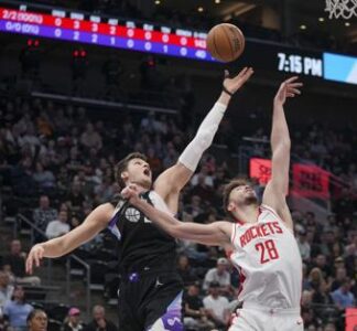 Houston Rockets center Alperen Sengun (28) and Utah Jazz center Walker Kessler, behind, reach for a rebound during the first half of an NBA basketball game Thursday, March 27, 2025, in Salt Lake City. (AP Photo/Bethany Baker)