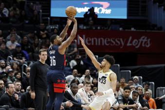 Washington Wizards guard Marcus Smart (36) shoots a three point basket against Utah Jazz guard Johnny Juzang (33) during the first half of an NBA basketball game, Wednesday, Mar. 5, 2025, in Washington. (AP Photo/Terrance Williams)