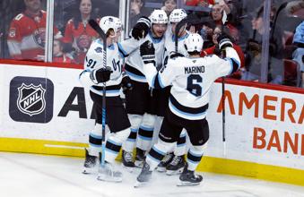 Utah Hockey Club defenseman Sean Durzi (5)) celebrates after his goal with teammates during the third period of an NHL hockey game against the Florida Panthers, Friday, March 28, 2025, in Sunrise, Fla. (AP Photo/Rhona Wise)