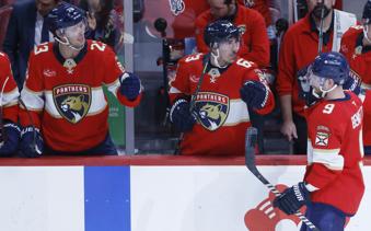 Florida Panthers center Sam Bennett (9) celebrates after his goal with center Carter Verhaeghe (23) and center Brad Marchand (63) during the second period of an NHL hockey game against the Utah Hocket Club, Friday, March 28, 2025, in Sunrise, Fla. (AP Photo/Rhona Wise)