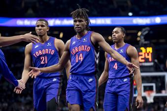 Toronto Raptors guard Ja'Kobe Walter (14) is congratulated by teammates during first-half NBA basketball game action against the Utah Jazz in Toronto, Friday, March 7, 2025. (Christopher Katsarov/The Canadian Press via AP)