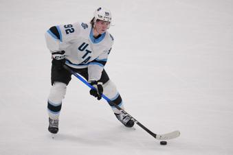Utah Hockey Club center Logan Cooley skates with the puck against the Dallas Stars during the third period of an NHL hockey game Saturday, April 12, 2025, in Dallas. (AP Photo/Julio Cortez)