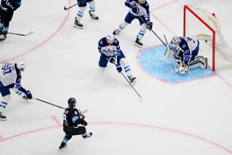 Utah Hockey Club center Clayton Keller (9) shoots and scores on Winnipeg Jets goaltender Connor Hellebuyck (37) during the first period of an NHL hockey game Saturday, April 5, 2025, in Salt Lake City. (AP Photo/Tyler Tate)