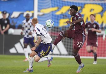 Colorado Rapids forward Darren Yapi, right, passes the ball as Real Salt Lake defender Justen Glad, left, covers in the first half of an MLS soccer match Saturday, May 17, 2025, in Commerce City, Colo. (AP Photo/David Zalubowski)